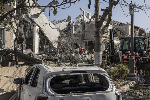 Petugas tanggap darurat melakukan pemeriksaan usai serangan Iran di salah satu perumahan di Tel Aviv, Israel, Sabtu (14/6/2025). Foto: John Wessels/AFP