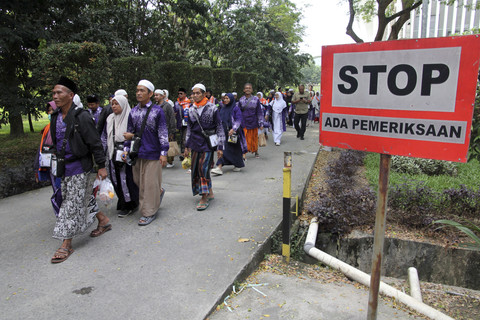 Jemaah haji penumpang pesawat Saudia Airlines SVA5688 berjalan menuju bus untuk dipindahkan ke hotel di Bandara Kualanamu, Sabtu (21/6/2025). Foto: Yudi Manar/ ANTARA FOTO