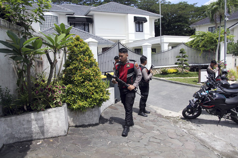 Polisi berjaga di gerbang rumah saat penyidik KPK melakukan penggeledahan terkait kasus dugaan korupsi proyek pembangunan jalan di rumah pribadi Kepala Dinas PUPR Provinsi Sumatera Utara Topan Obaja Putra Ginting di Medan, Sumatera Utara, Rabu (2/7). Foto: Yudi Manar/ ANTARA FOTO
