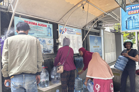 Sejumlah warga antre untuk mengambil air minum gratis di kawasan Rawamangun, Jakarta, Sabtu (12/7/2025). Foto: Abid Raihan/kumparan