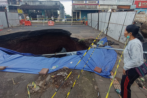 Warga mengamati kondisi jalan amblas di jalur Denpasar-Gilimanuk, Desa Bajera, Tabanan, Bali, Selasa (8/7/2025). Foto: Nyoman Hendra Wibowo/ANTAR... </div>
<div class=