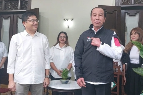 Plt Ketum PSI Andy Budiman memberikan jaket PSI ke Jokowi di Solo, Kamis (17/7/2015). Foto: kumparan