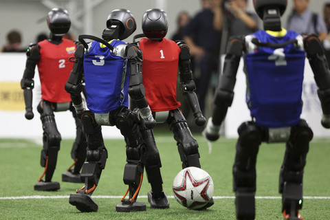 Robot humanoid Booster Robotics T1 bermain sepak bola saat mendemonstrasikan permainan sepak bola 5 lawan 5 di Beijing, China, Senin (4/8/2025). Foto: Florence Lo/REUTERS