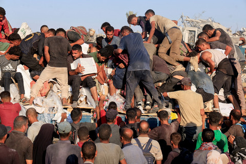 Warga Palestina berebut pasokan bantuan di Khan Younis, Jalur Gaza selatan, Senin (4/8/2025). Foto: Hatem Khaled/REUTERS