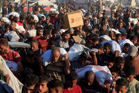 Warga Palestina membawa pasokan bantuan di Khan Younis, Jalur Gaza selatan, Senin (4/8/2025). Foto: Hatem Khaled/REUTERS