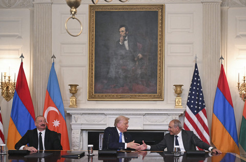 Presiden AS Donald Trump (tengah) dan Perdana Menteri Armenia Nikol Pashinyan berjabat tangan sementara Presiden Azerbaijan Ilham Aliyev menonton setelah menandatangani perjanjian di Gedung Putih di Washington DC, Jumat (8/8/2025). Foto: Andrew Caballero-Reynolds/AFP