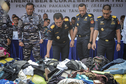 Panglima Komando Armada Republik Indonesia (Pangkoarmada RI) Laksamana Madya TNI Denih Hendrata bersama Dirjen Bea Cukai Djaka Budi Utama menunjukan barang bukti sitaan pakaian bekas di Pelabuhan Tanjung Priok, Jakarta, Rabu (14/8/2025). Foto: Iqbal Firdaus/kumparan