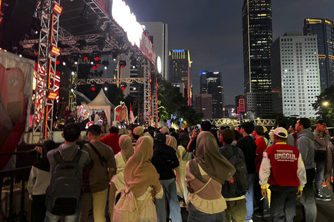 Sejumlah warga mulai berkumpul untuk mengikuti rangkaian HUT ke-80 RI di Dukuh Atas, Sudirman, Jakarta Pusat, Minggu (17/8/2025). Foto: Rayyan Farhansyah/kumparan