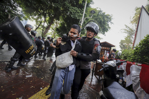 Salah satu aparat megamankan seorang massa aksi saat demo di belakang DPR hingga kawasan stasiun Palmerah, Jakarta, Senin (25/8/2025). Foto: Jamal Ramadhan/kumparan