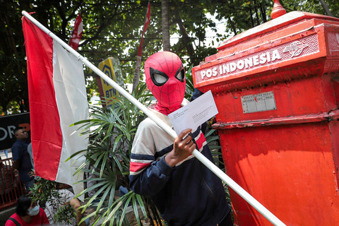 Seorang warga mengenakan kostum Spider-Man menunjukkan surat berisi desakan kepada Komisi Pemberantasan Korupsi (KPK) terkait dugaan korupsi Bupati Pati Sudewo untuk dikirimkan melalui Kantor Pos Pati di Kabupaten Pati, Jawa Tengah Senin (25/8/2025). Foto: Iqbal Firdaus/kumparan