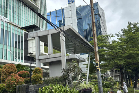 Kondisi kabel-kabel semrawut yang menjuntai di sepanjang Trotoar Jalan DI Panjaitan, Cawang, Jaktim, Kamis (18/12/2025). Foto: Abid Raihan/kumparan