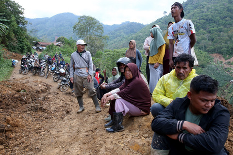Warga antre untuk melintasi badan jalan lintas Geumpang-Pameu-Takengon saat dibersihkan dengan menggunakan alat berat di Desa Panton Tengah, Rusip Antara, Aceh Tengah, Aceh, Rabu (24/12/2025). Foto: ANTARA FOTO/Irwansyah Putra