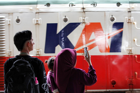 Sebuah keluarga menyaksikan lokomotif kereta api memasuki Stasiun Surabaya Gubeng, Surabaya, Jawa Timur, Selasa (6/1/2026). Foto: Didik Suhartono/ANTARA FOTO