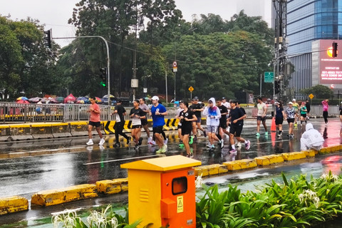 Warga tetap antusias lari pagi meskipun diguyur hujan pada saat CFD Thamrin-Sudirman, Jakarta Pusat, Minggu pagi (18/1/2026). Foto: Jeni Ritanti/kumparan