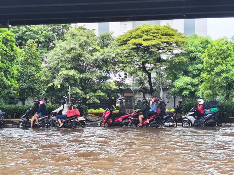 Kendaraan dialihkan ke jalur yang lebih tinggi guna melewati banjir di Jalan Ahmad Yani, Cempaka Putih, Jakarta Pusat, Minggu (18/1/2026). Foto: Jeni Ritanti/kumparan