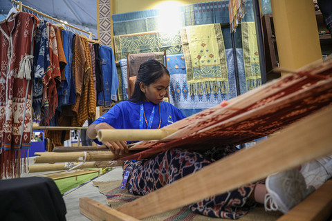 Pengrajin kain tenun saat mempraktikkan pembuatan tenun di pameran BCA Expoversary 2026 yang diselenggarakan di ICE BSD, Tangerang, Jumat (6/2/2026). Foto: Aditia Noviansyah/kumparan