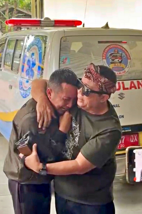 Ayah NS, Anwar Satibi menangis di samping mobil ambulan yang akan membawa jenazah anaknya. Foto: Dok. Sukabumi Update