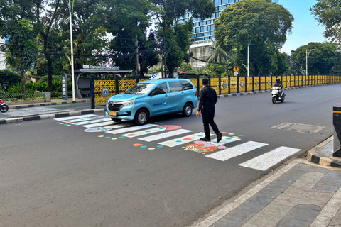 Warga yang tengah menyeberang di zebra cross bergambar di Jalan Dr. Soepomo, Jakarta Selatan, Minggu (29/3/2026). Foto: Ryan Iqbal/kumparan