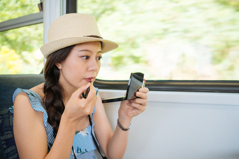 Ilustrasi perempuan dandan dalam kereta. Foto: PR Image Factory/Shutterstock