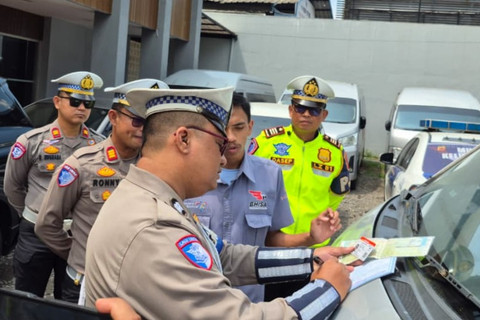 Polisi melakukan tilang manual kepada sopir travel yang membahayan pengendara lain di Tol Jakarta-Cikampek. Foto: Dok. Istimewa