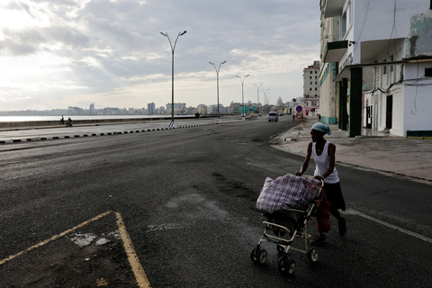 Warga mendorong troli saat lalu lintas sepi di Havana, Kuba, Jumat (15/5/2026). Foto: Norlys Perez/ REUTERS