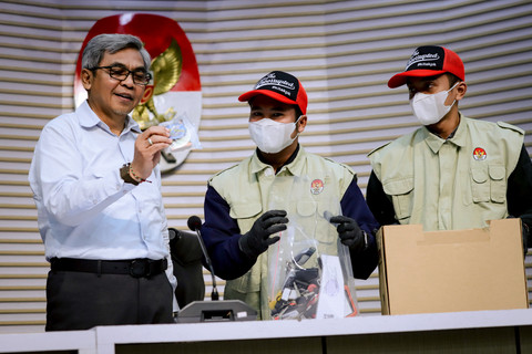 Petugas menunjukkan barang bukti OTT dugaan korupsi pengurusan izin tinggal WNA saat konferensi pers yang dipimpin Ketua KPK Setyo Budiyanto di Gedung Merah Putih KPK, Jakarta, Kamis (4/6/2026). Foto: Jamal Ramadhan/kumparan