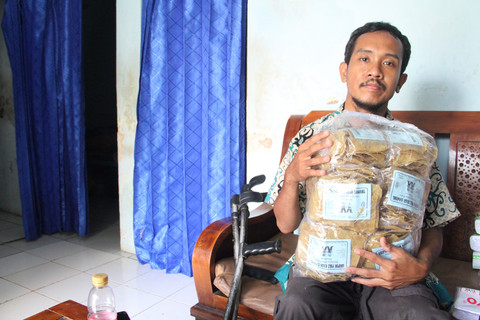 Abdul Muis (31) menunjukkan dagangan kerupuknya.  Foto: Vega Maarijil Ula/kumparan