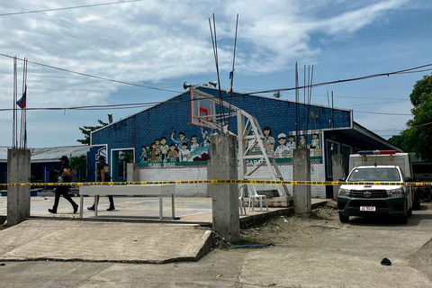 Penyidik kepolisian berada di lokasi kejadian penembakan di kompleks sekolah menengah di Kota Tacloban, Provinsi Leyte, Filipina, pada 22 Juni 2026. Foto: Noel Sianosa / AFP