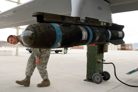 Rudal Hellfire inersia pada pesawat tanpa awak (drone) MQ-1B Predator saat melakukan inspeksi pra-penerbangan di Pangkalan Angkatan Udara Creech, Indian Springs, Nevada, Amerika Serikat, (16/4/2009). Foto: Ethan Miller/AFP