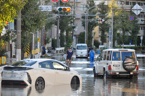 Ilustrasi mobil melewati banjir. Foto: AFP/Jiji Press