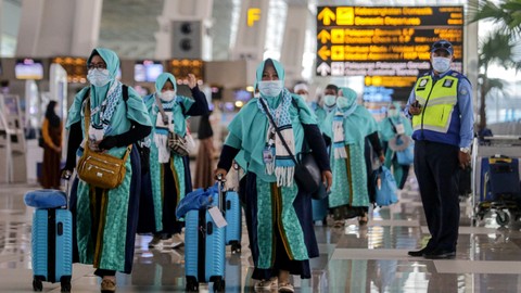 Sejumlah calon jemaah umrah berjalan di Terminal 3 Bandara Internasional Soekarno-Hatta, Tangerang, Banten, Sabtu (8/1/2022). Foto: Fauzan/ANTARA FOTO