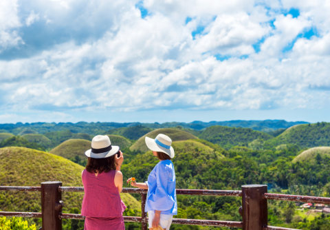 Wisatawan yang sedang berfoto di Bukit Cokelat di Filipina Foto: Shutter Stock