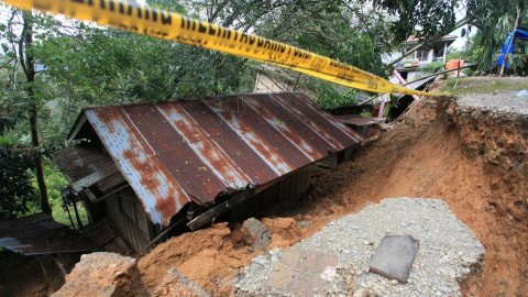 Sebuah rumah amblas terkena bencana tanah bergerak, di tepi jalan Nagari Koto Alam, Kabupaten Limapuluhkota, Sumatera Barat, Sabtu (21/12/2019). Foto: ANTARA FOTO/Adi Prima