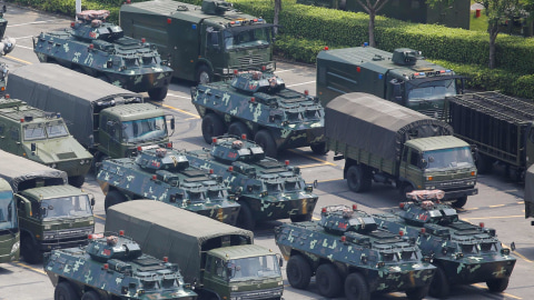 Kendaraan militer milik China tampak terparkir di  Shenzhen Bay Sports Center, Shenzhen, China, dekat dengan perbatasan Hong Kong. Foto: Reuters