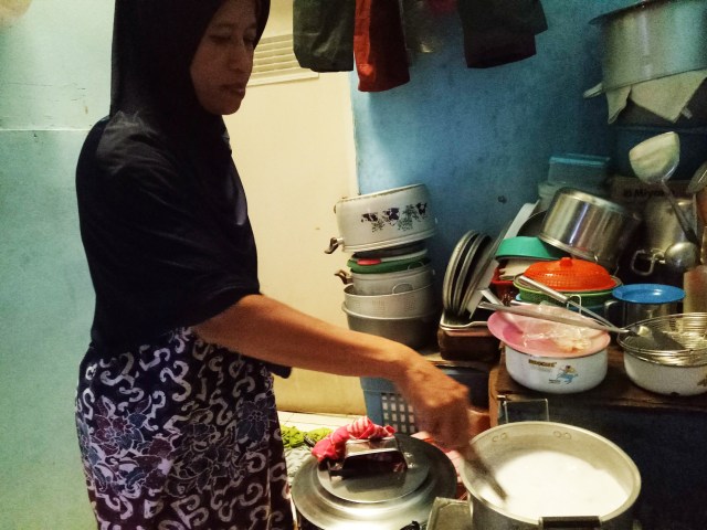 Bu Nurjanah memasak nasi uduk dan lauk-lauknya (Foto: Kevin Kurnianto/kumparan)