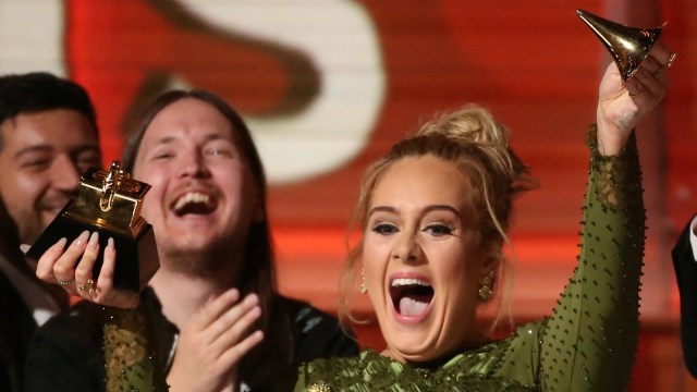 Adele mematahkan piala Grammy Awards. (Foto: REUTERS/Lucy Nicholson)