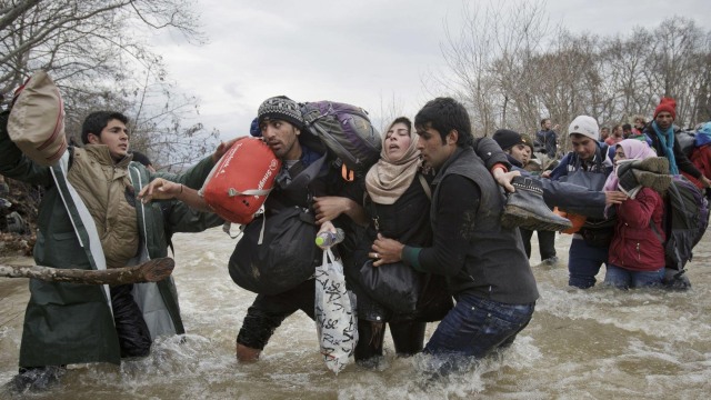 Imigran Timur Tengah melalui sungai perbatasan. (Foto: Vadim Ghirda/Associated Press)
