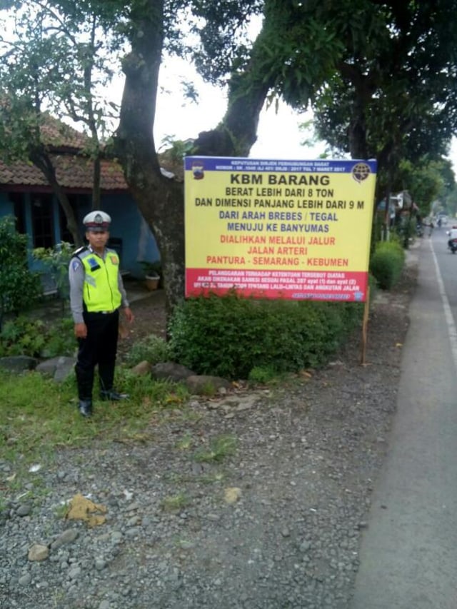 Seorang polisi berjaga di perlintasan jalan. (Foto: Dok. Polres Brebes)