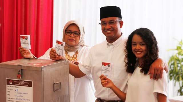 Anies dan keluarga menunjukan surat suara. (Foto: Reuters/Beawiharta)