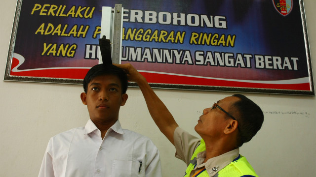 Petugas mengukur tinggi calon polisi. (Foto: ANTARA FOTO/Muhammad Iqbal)