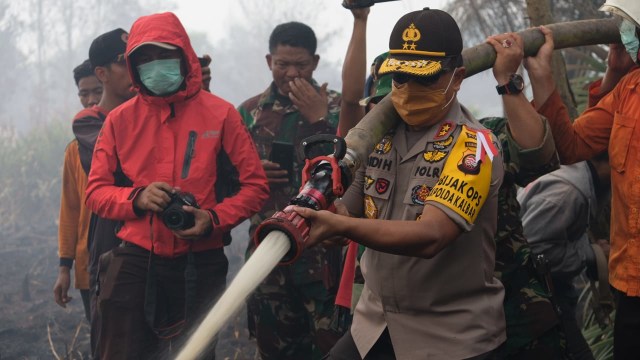 Petugas berjibaku padamkan kebakaran lahan gambut di Kalimantan Barat, Jumat (17/8/18). (Foto: dok Polda Kalbar)
