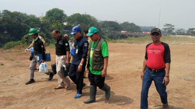 Petugas mengecek pipa yang mengeluarkan cairan hitam di Sungai Cileungsi. (Foto: Dok. Ketua Komunitas Peduli Sungai Cileungsi-Cikeas, Puarman)