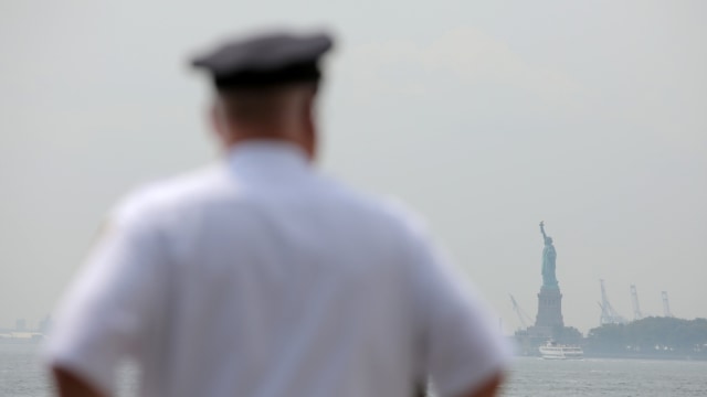 Polisi berjaga di dekat Patung Liberty di Pulau Liberty di Manhattan, New York, AS, Selasa (28/8/2018). Foto: Reuters/Andrew Kelly