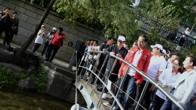 Presiden Jokowi didampingi Seskab Pramono Anung dan rombongan berjalan-jalan di pinggir Sungai Cheonggyecheon, Seoul, Korsel, Selasa (11/9/2018). (Foto: Setkab.go.id)