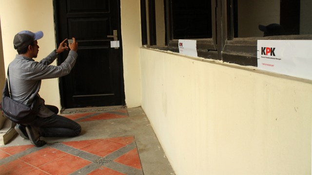 Wartawan memotret ruangan kantor Dinas Pekerjaan Umum dan Penataan Ruang (PUPR) yang tersegel stiker KPK usai Operasi Tangkap Tangan (OTT). (Foto: ANTARA FOTO/Risky Andrianto)