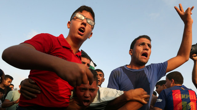 Protes Warga Palestina di Gaza. (Foto: REUTERS/Ibraheem Abu Mustafa)