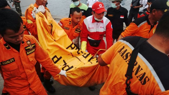 Petugas membawa kantong jenazah korban pesawat Lion Air JT-610 di Dermaga JICT, Selasa (30/10/2018). (Foto: Irfan Adi Saputa/kumparan)