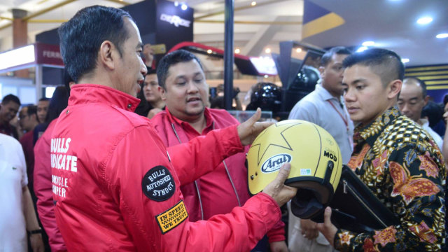 Presiden Joko Widodo melihat alah satu helm yang ada saat mengunjungi Indonesia Motorcycle Show (IMOS) 2018. (Foto: Intan/Biro Pers Setpres)