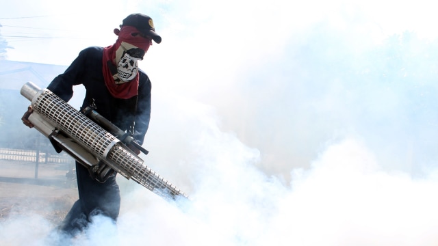 Petugas Dinas Kesehatan Kota Makassar menyemprotkan asap (fogging) di Kompleks Nikel, Makassar, Sulawesi Selatan, Selasa (13/11). (Foto:  ANTARA FOTO/Darwin Fatir)