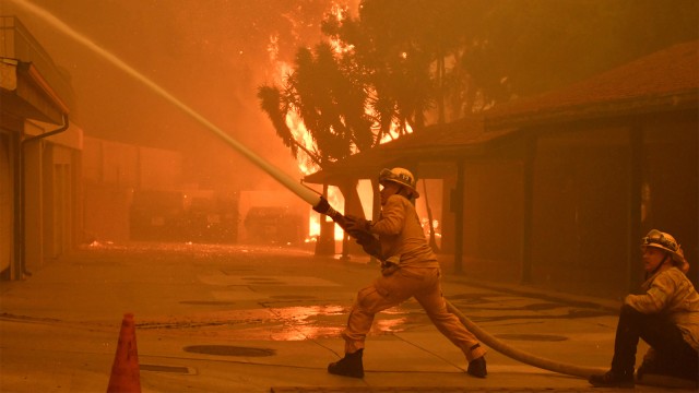 Petugas pemadam kebakaran berusaha memadamkan api yang membakar hutan dan tempat tinggal di Malibu, California, AS. (Foto: REUTERS / Gene Blevins)